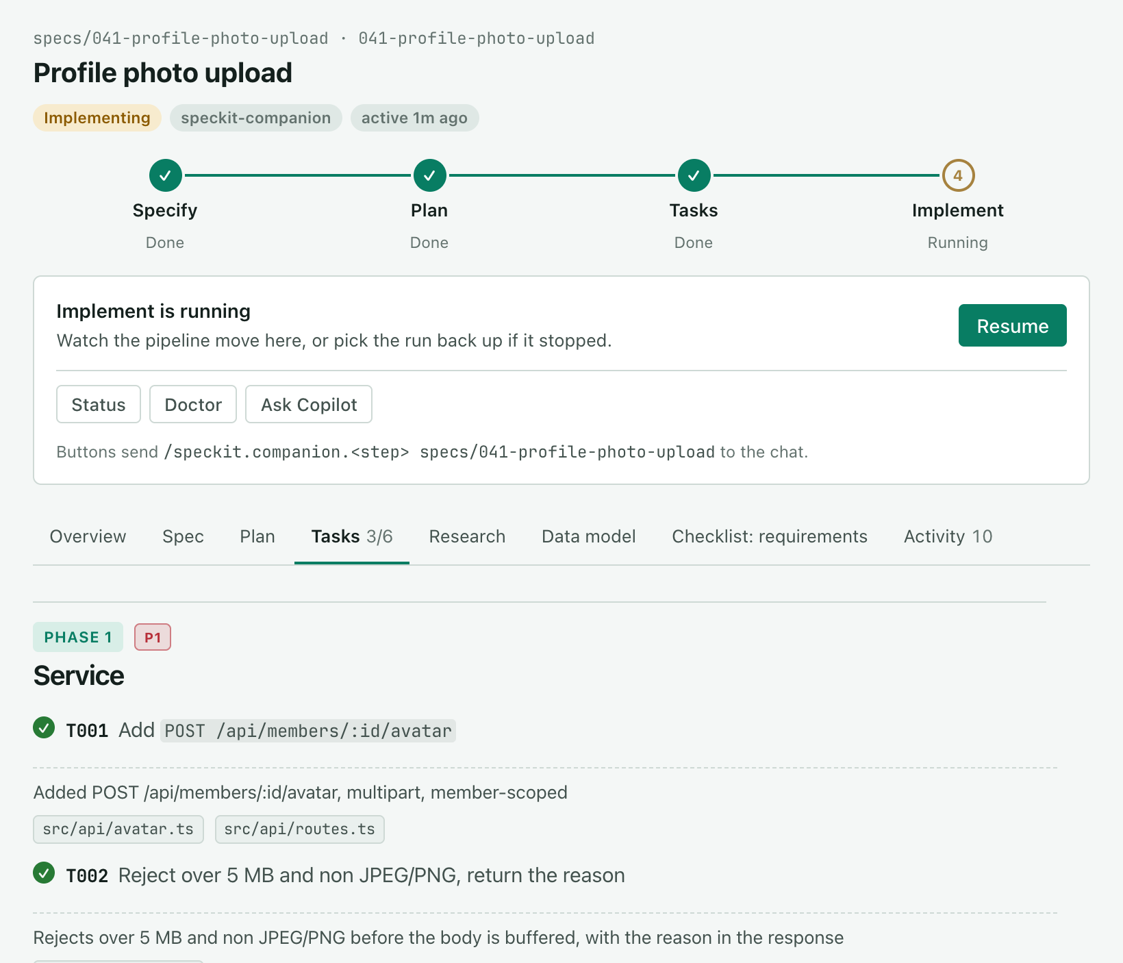 The same spec during implement. The status reads Implementing, Implement is running in the pipeline, the card reads Implement is running with a Resume button, and the Tasks tab reads 3/6 with T001 and T002 ticked and the files each one touched.