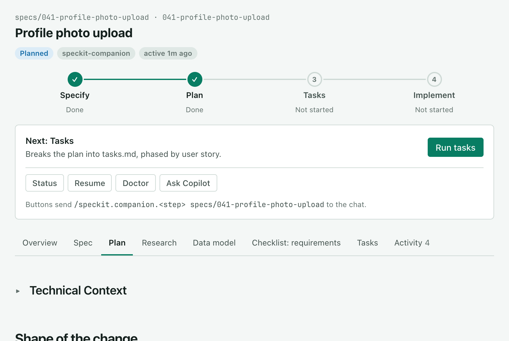 The same spec after plan. The status reads Planned, Specify and Plan are done, the card reads Next: Tasks with a Run tasks button, and the Plan tab is open on the plan.