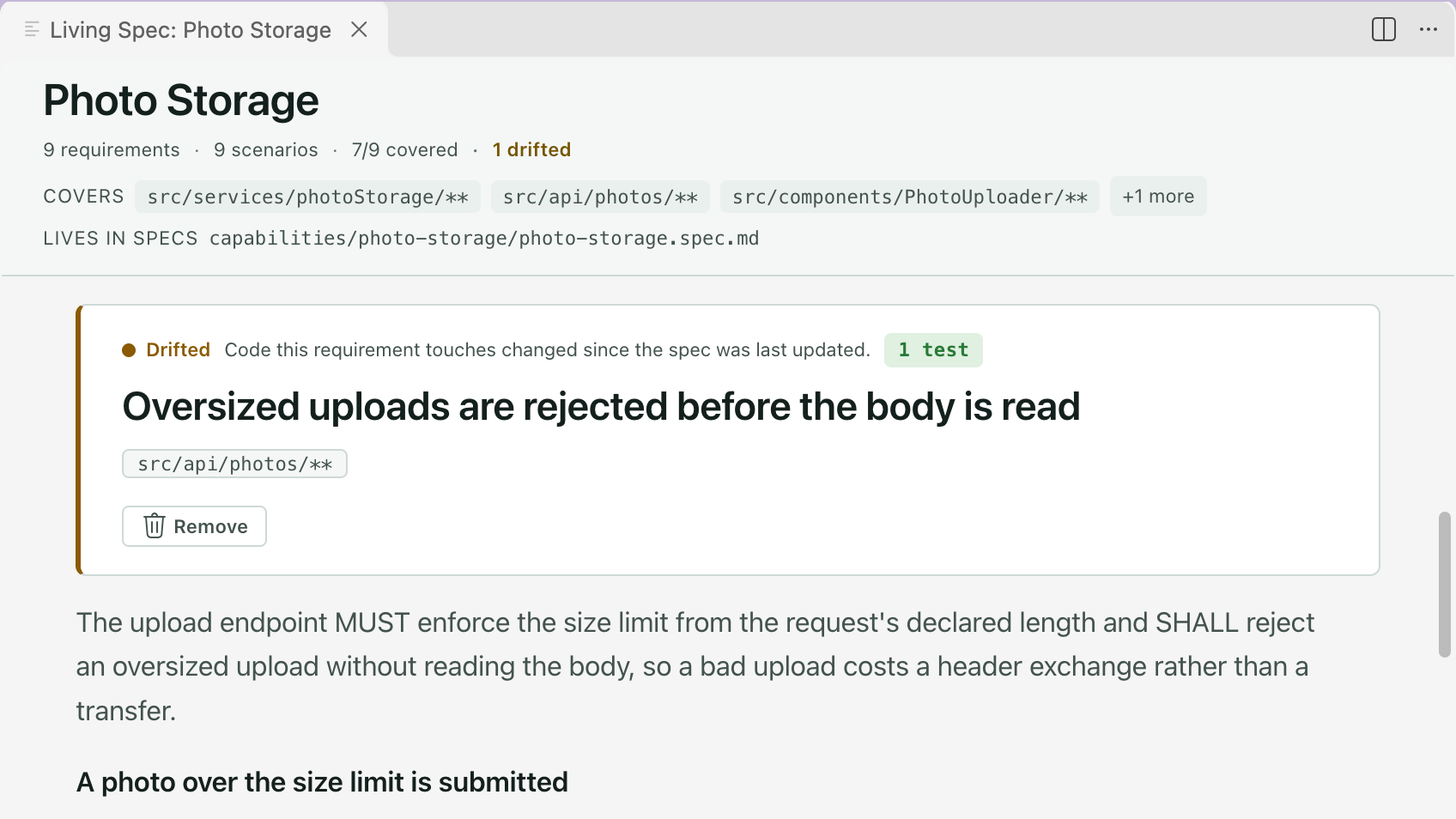 A living spec scrolled to one requirement marked Drifted, with a line saying the code it touches changed since the spec was last updated. The header counts 1 drifted.