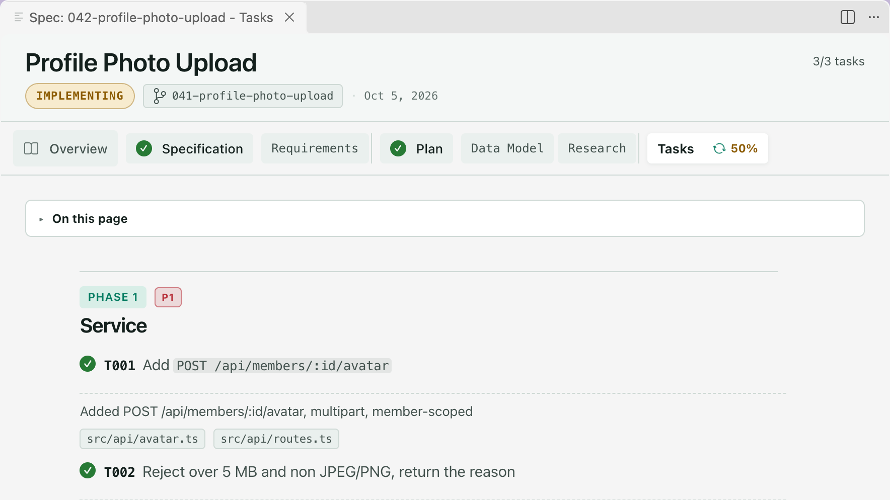 The Tasks tab of Profile Photo Upload during implement. The badge reads Implementing, the Tasks tab shows 50%, and under Phase 1 tasks T001 and T002 are ticked, each with a line saying what was done and the files it touched.